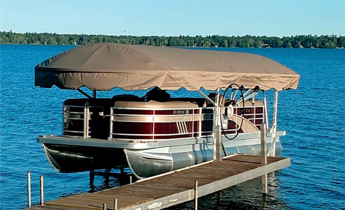Tan Shoretex boat lift canopy over pontoon